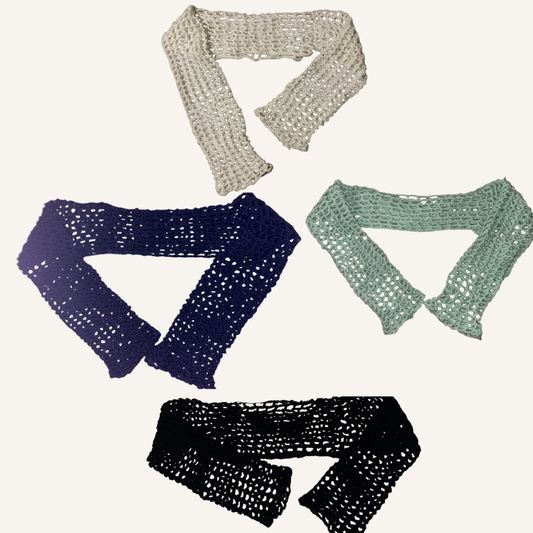 Four crochet mesh shrugs in different colors on a white background