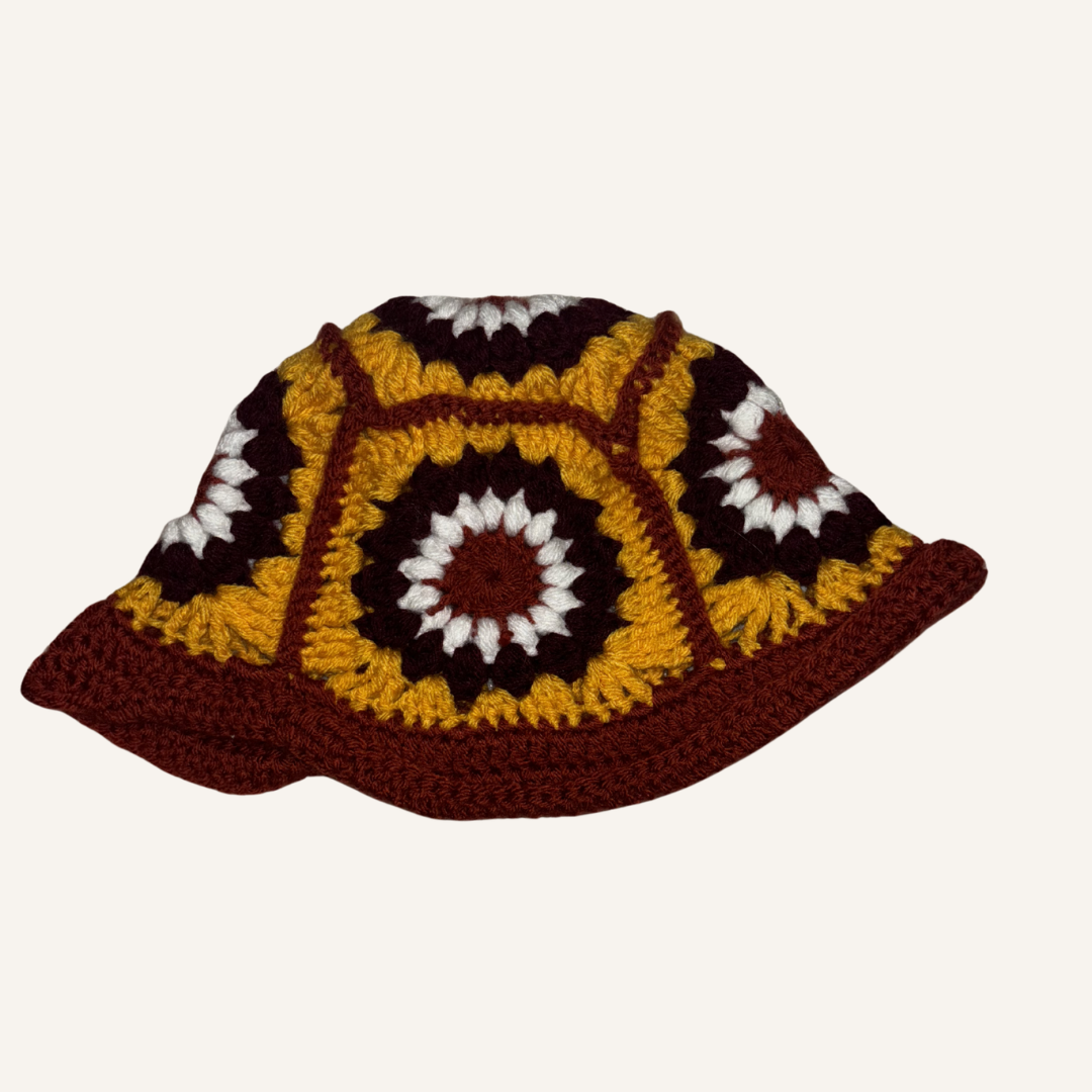 Crocheted bucket hat with a colorful pattern on a white background