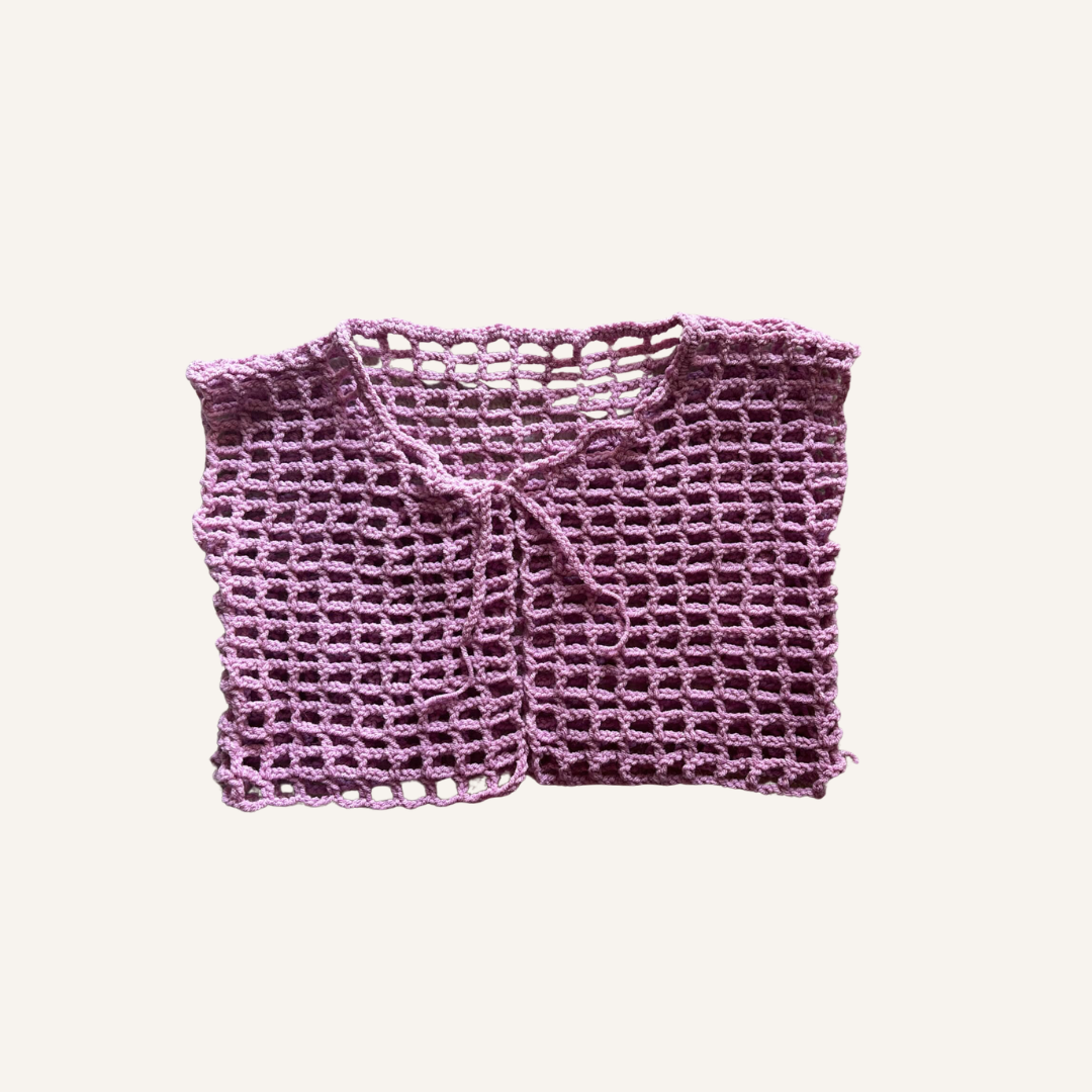 Purple crochet mesh garment on a light pink background