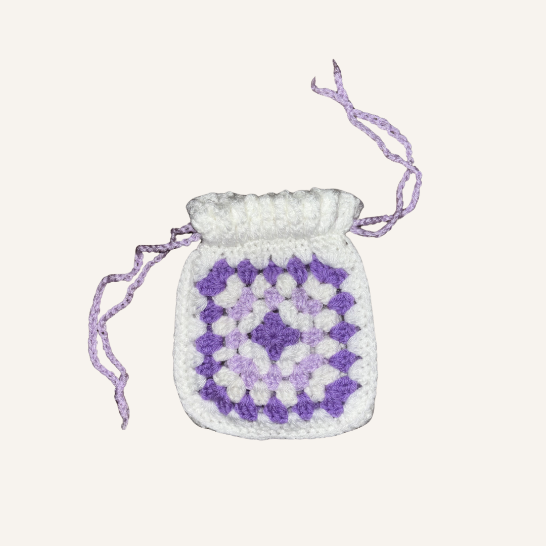 Purple and white Granny Square crocheted Pouch Against white background