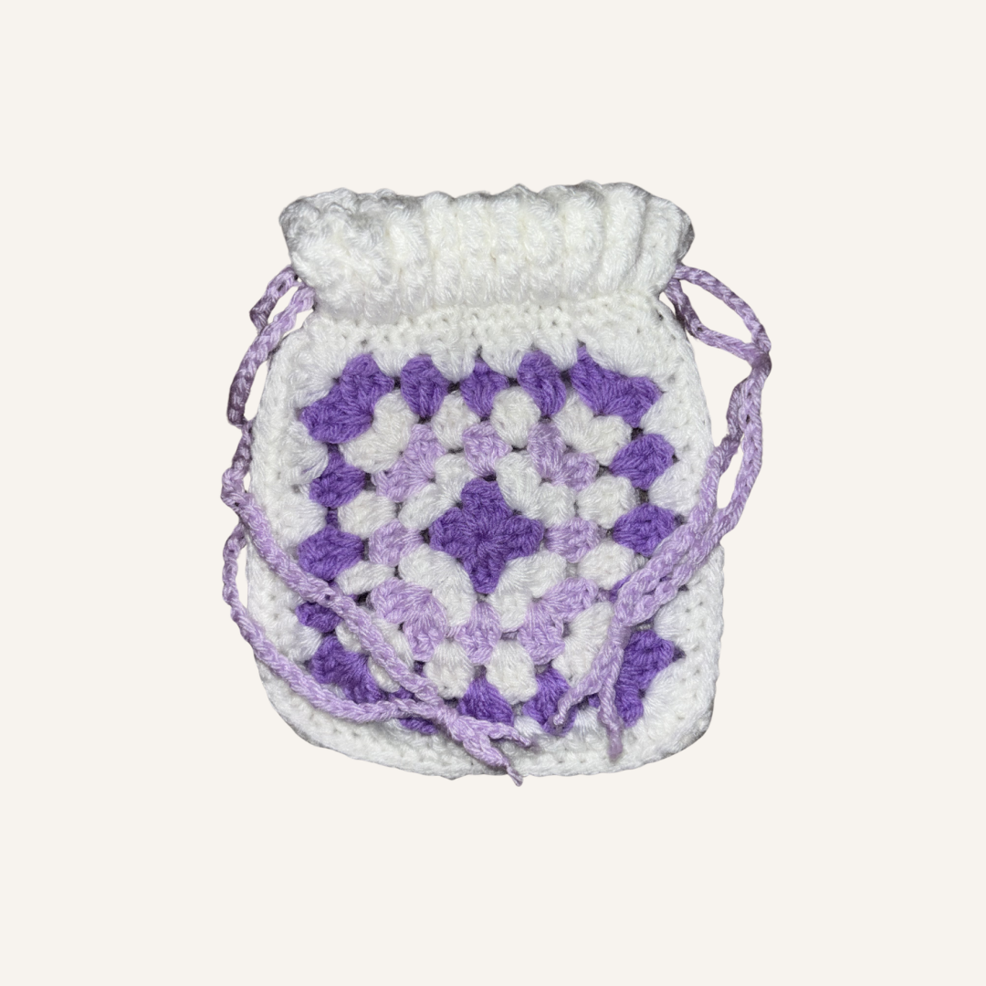 Purple and white crocheted granny square bag on white background