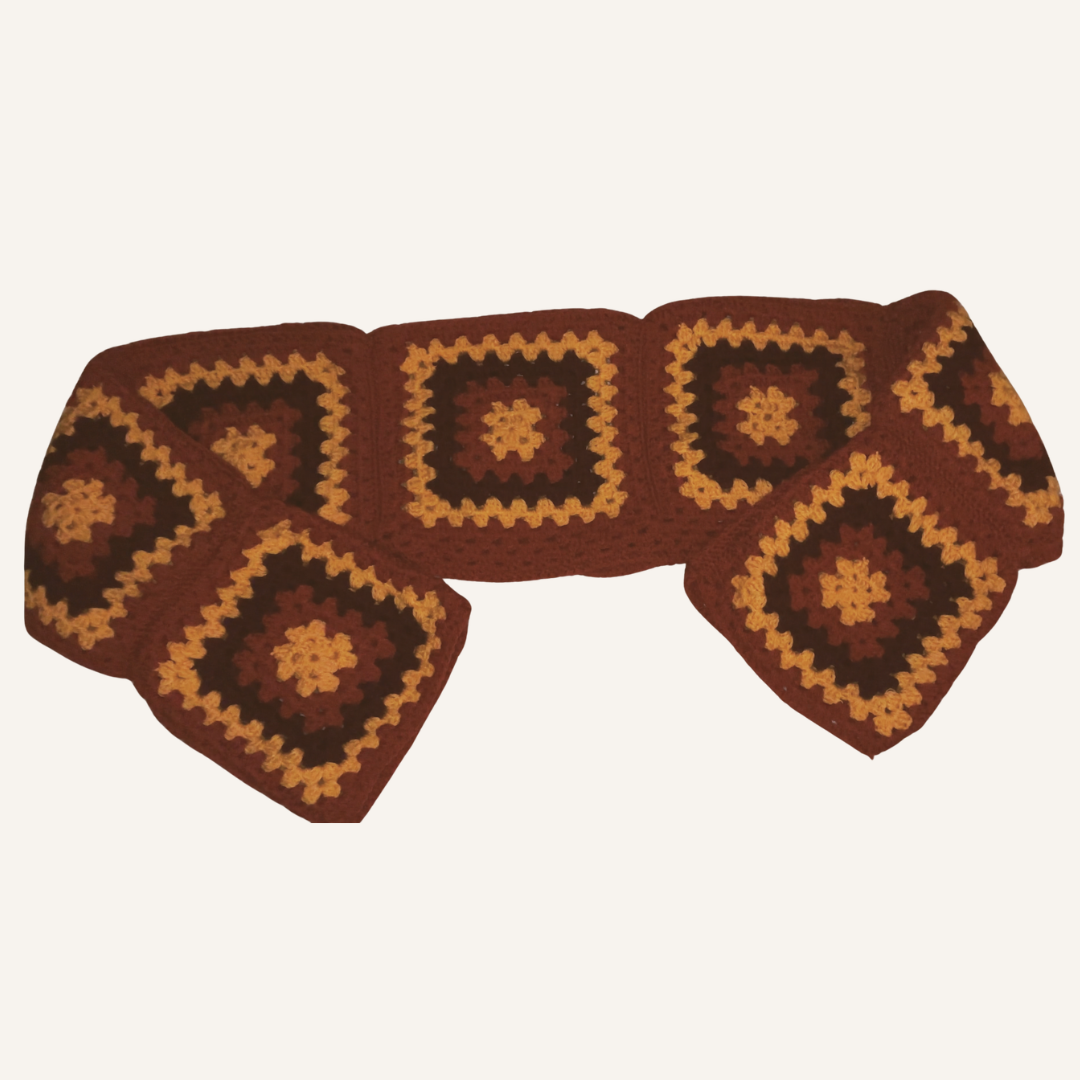 Crocheted sweater with a granny square pattern on a white background