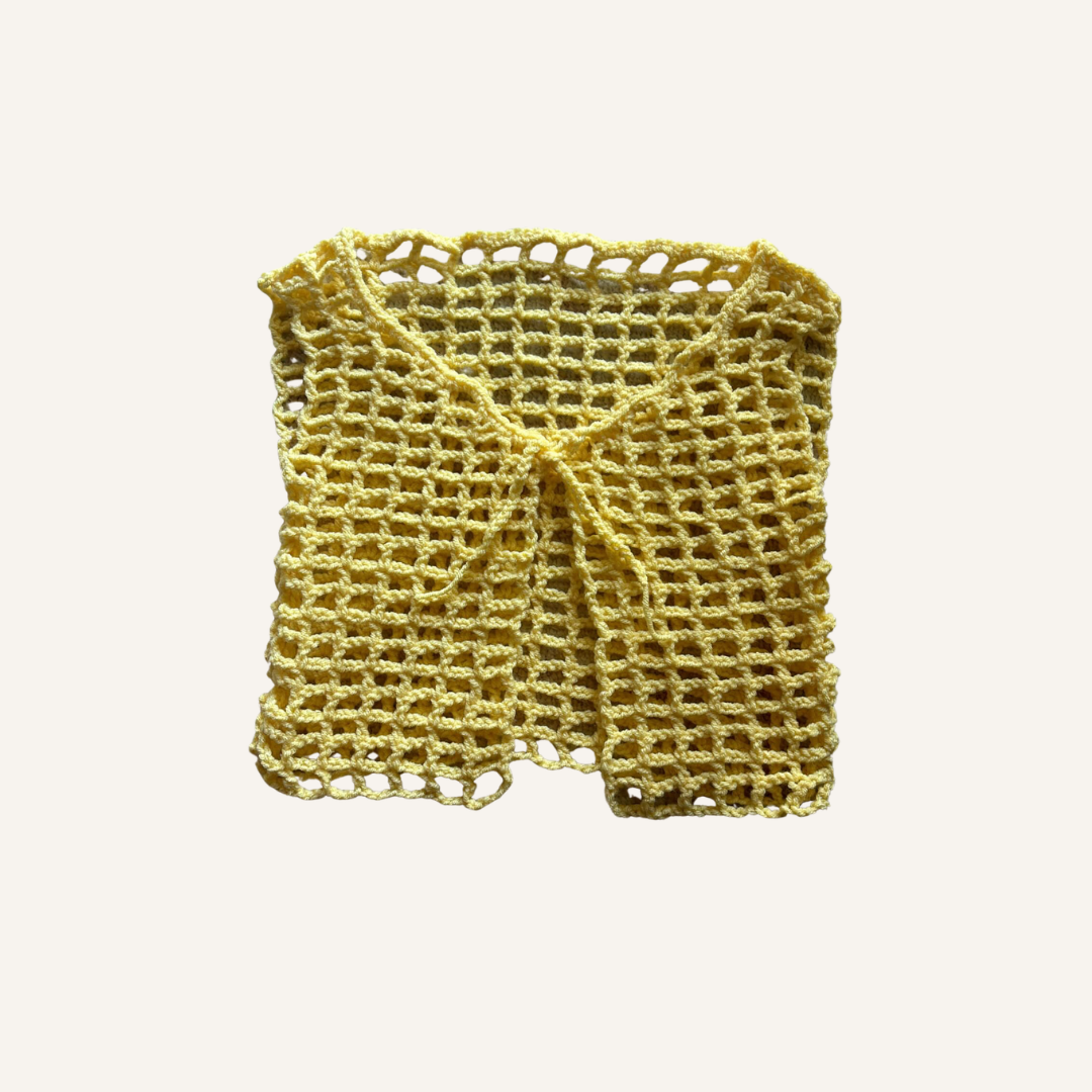 Yellow crochet mesh top on a white background